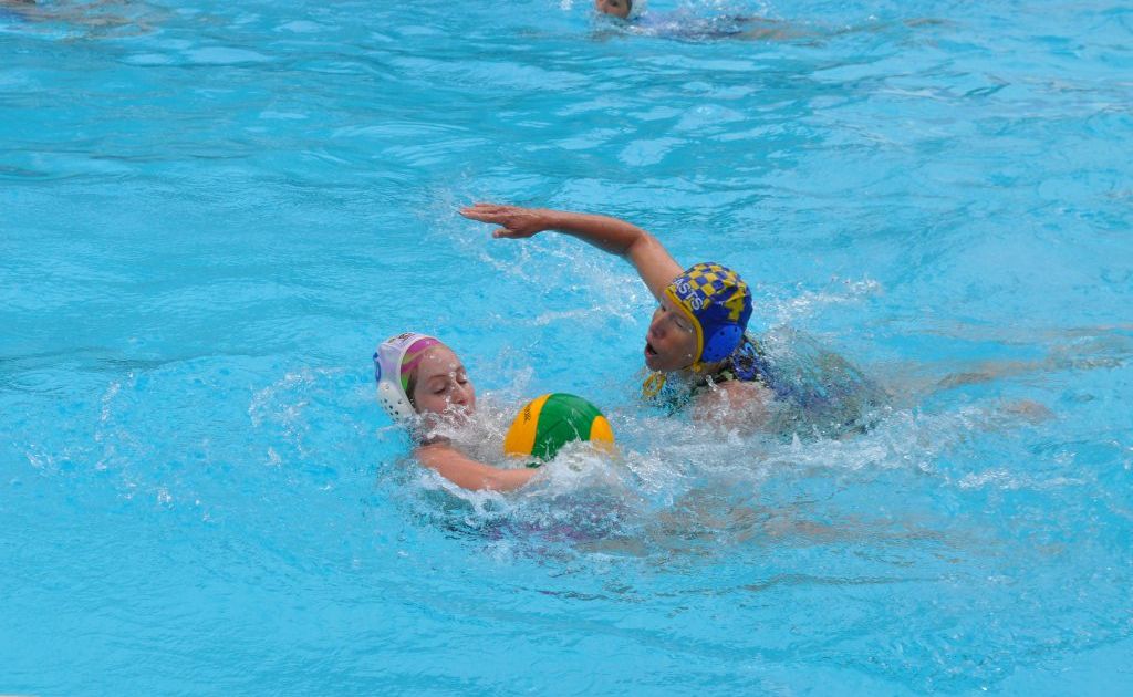 CRAFTY STEAL: Coffs Harbour Water Polo Club’s Cheryl Lane (blue and yellow cap) manages to intercept Holly Whyte-Butler’s pass during a game against Manning Valley at Wingham. CRAFTY STEAL: Coffs Harbour Water Polo Club’s Cheryl Lane (blue and yellow cap) manages to intercept Holly Whyte-Butler’s pass during a game against Manning Valley at Wingham.